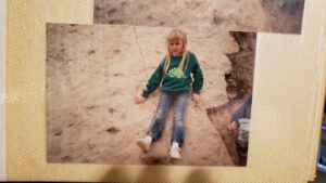 IMG_0544 Erin as a child sitting near dinosaur tracks
