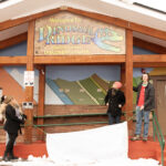 Martin Lockley's children pull a cover off a new sign on the front of the newly renamed Martin G. Lockley Discovery Center building.