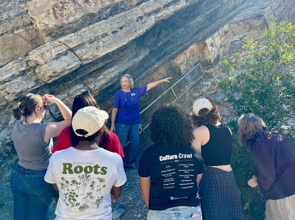 Dr. Libby Prueher points to an ash layer on Dinosaur Ridge.