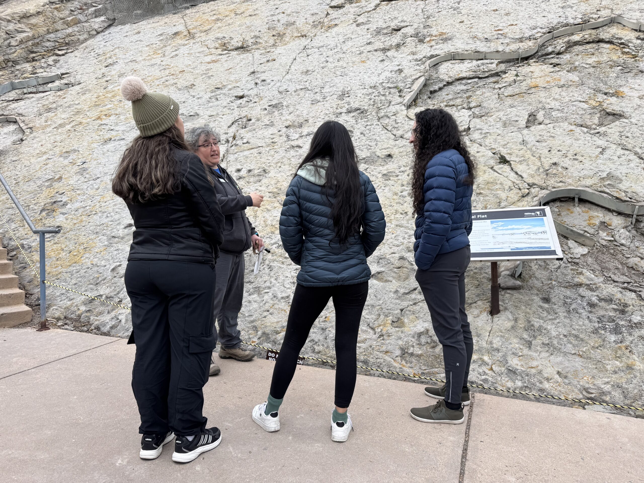 Tour Guide speaks with visitors at the Main Tracksite on Dinosaur Ridge.