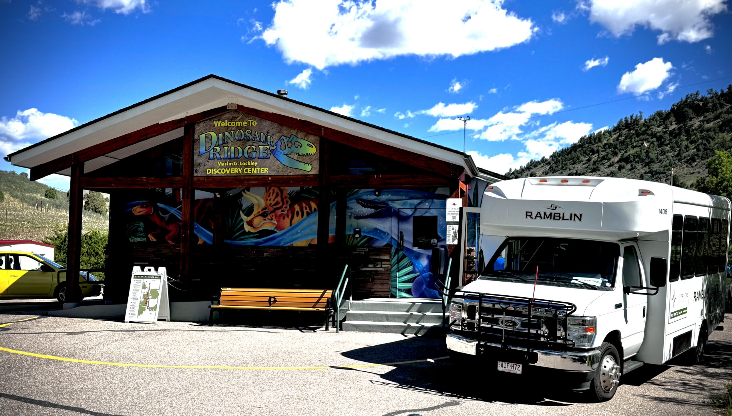 Exterior photo of the Martin G. Lockley Discovery Center on opening day with a Westracks shuttle parked out front.